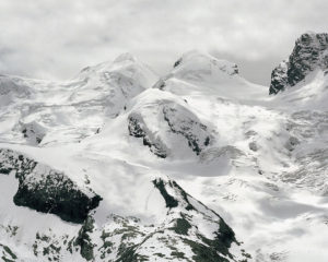 Photographie massif montagneux recouvert de neige et de glaciers sous un ciel couvert et lumineux, tirage pigmentaire contrecollé sur alu.